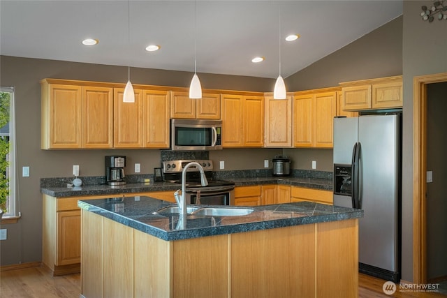 kitchen with stainless steel appliances, a sink, a center island with sink, light wood-type flooring, and vaulted ceiling