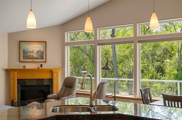 dining room featuring a fireplace and vaulted ceiling