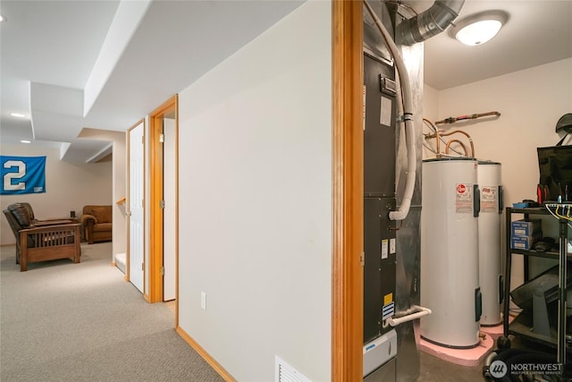 utility room featuring water heater and visible vents