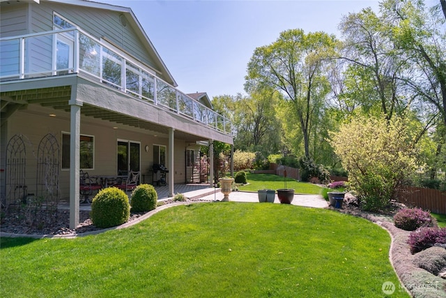 view of yard with a wooden deck, a patio area, and fence
