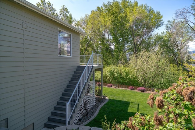 view of yard featuring stairway and fence