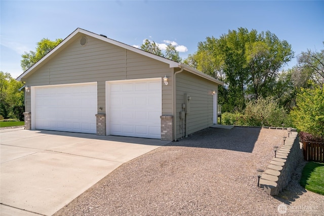 detached garage featuring fence