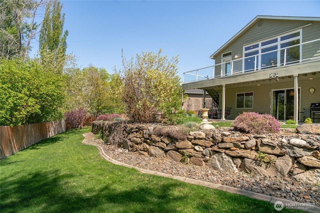 view of yard featuring fence and a deck