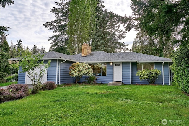 ranch-style home featuring a chimney, entry steps, a front yard, and an attached garage