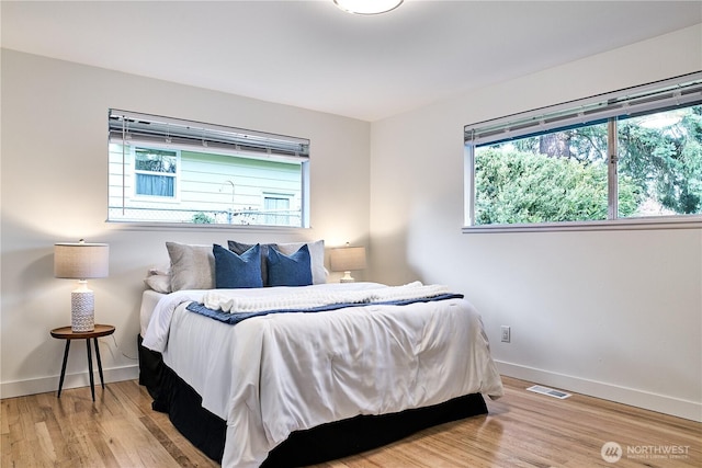 bedroom featuring baseboards and wood finished floors