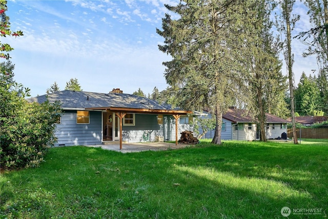 rear view of property with a patio and a chimney