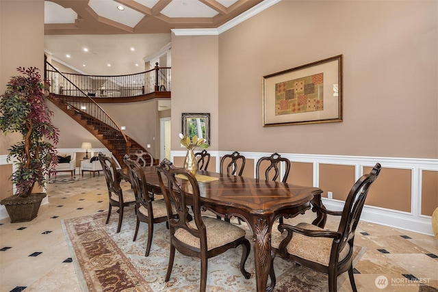 dining space with recessed lighting, stairway, a towering ceiling, coffered ceiling, and crown molding