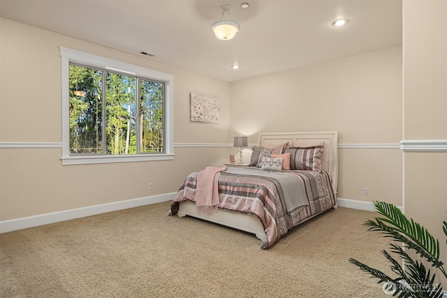 carpeted bedroom with visible vents, baseboards, and recessed lighting