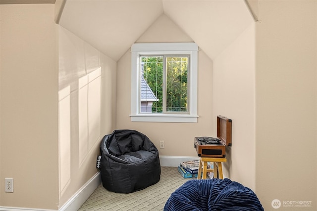 living area with vaulted ceiling, carpet flooring, and baseboards