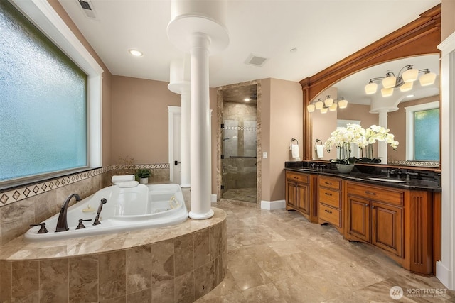 bathroom featuring a bath, a shower stall, visible vents, and ornate columns
