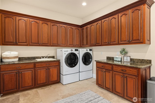 laundry area featuring cabinet space, independent washer and dryer, and a sink