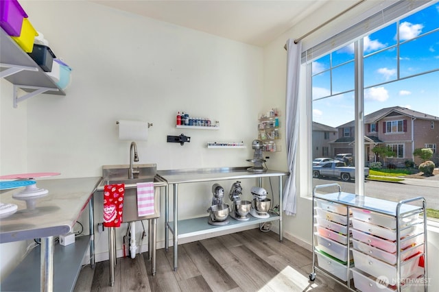 interior space featuring baseboards and wood finished floors