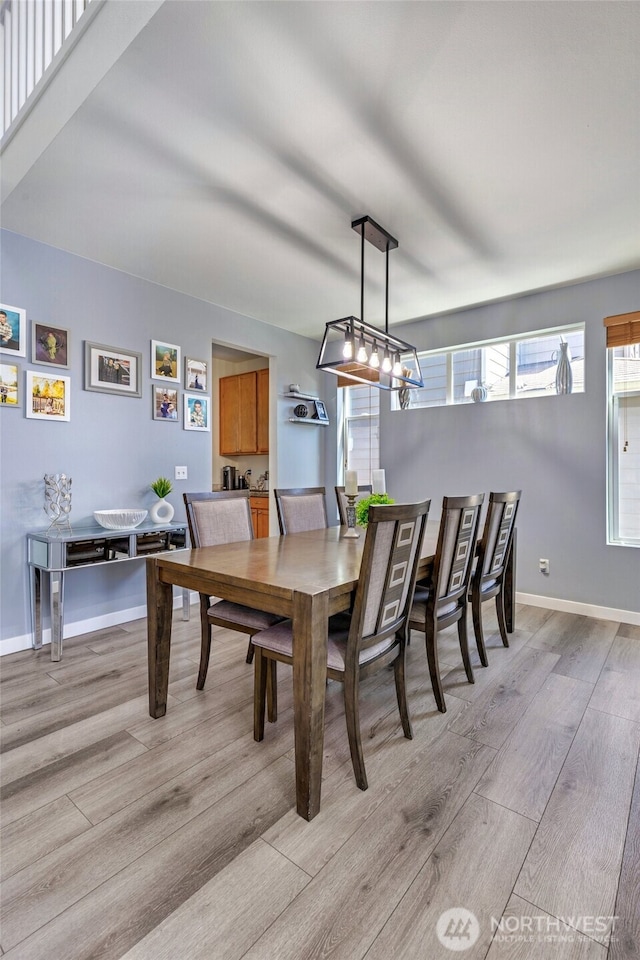 dining room featuring baseboards and light wood-style floors