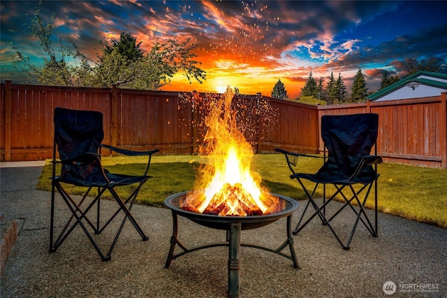 view of patio / terrace with an outdoor fire pit and fence private yard
