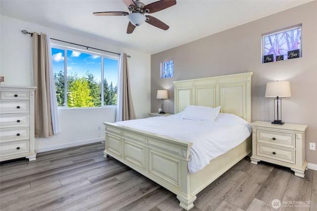 bedroom featuring light wood-style floors, baseboards, and ceiling fan