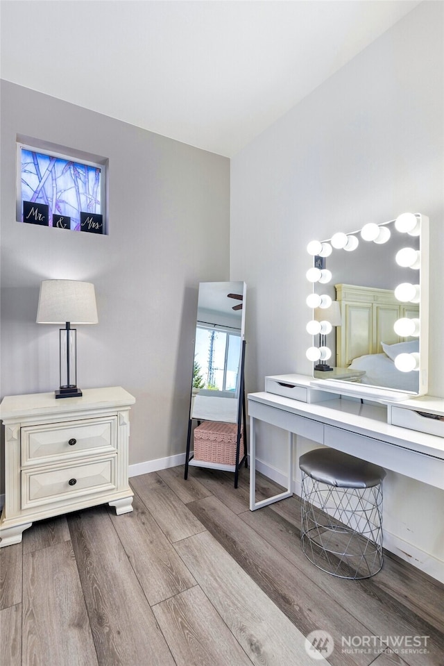 interior space featuring wood finished floors and baseboards