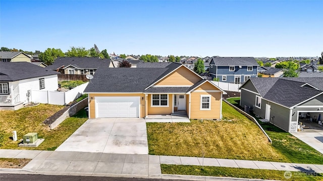 view of front facade with a front yard, a residential view, a garage, fence, and concrete driveway