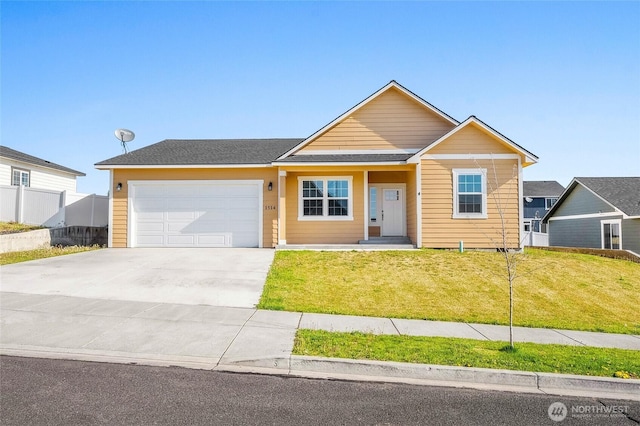 ranch-style house with a garage, a front lawn, and driveway