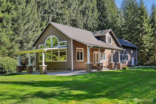 rear view of property with crawl space, a yard, a patio, and a shingled roof