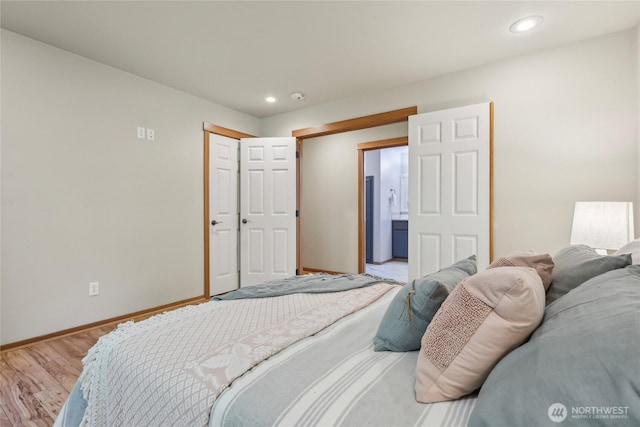 bedroom featuring baseboards, light wood-style floors, and recessed lighting