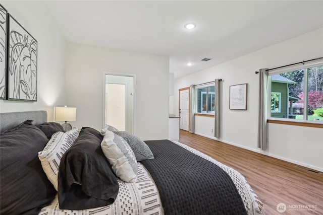 bedroom with recessed lighting, wood finished floors, visible vents, and baseboards