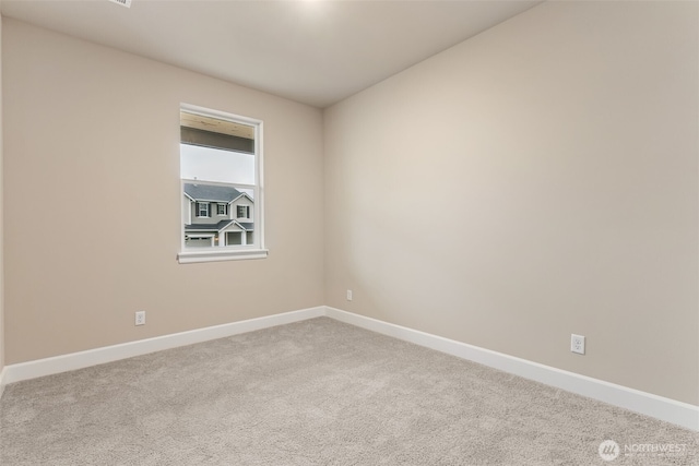 unfurnished room featuring baseboards and carpet flooring
