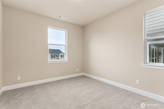unfurnished room with visible vents, carpet flooring, and baseboards