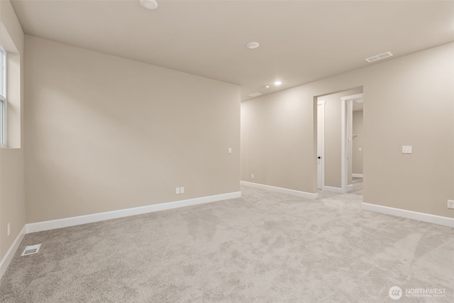 unfurnished room with recessed lighting, visible vents, light carpet, and baseboards