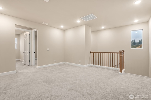 empty room with visible vents, light colored carpet, and recessed lighting