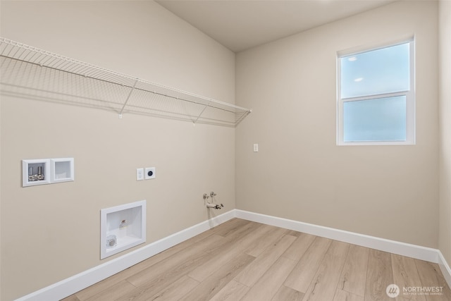 washroom with hookup for a gas dryer, laundry area, electric dryer hookup, light wood-style flooring, and baseboards