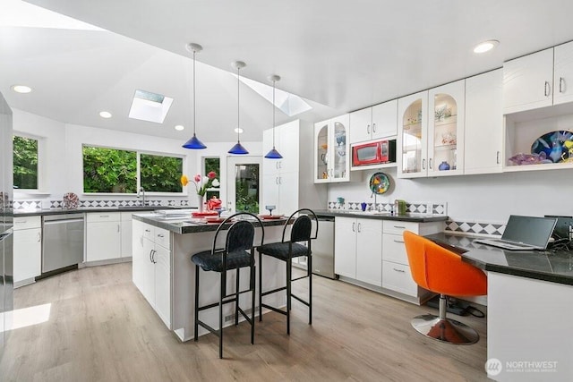 kitchen with light wood-style floors, a sink, and dishwasher
