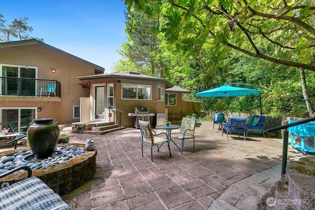 exterior space featuring grilling area and outdoor dining space