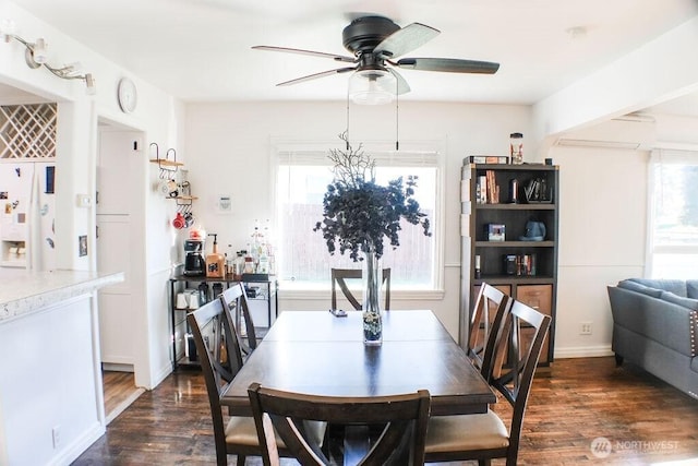 2916 Robin Ave, Bremerton, WA 98310 - dining room with a ceiling fan, a wall mounted AC, and dark wood-style flooring