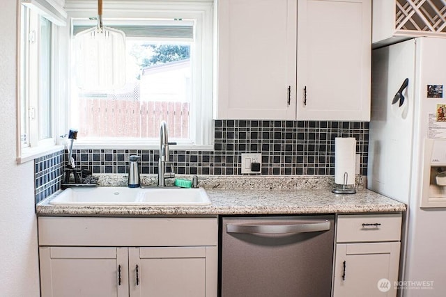 2916 Robin Ave, Bremerton, WA 98310 - kitchen with backsplash, stainless steel dishwasher, a sink, white fridge with ice dispenser, and white cabinetry