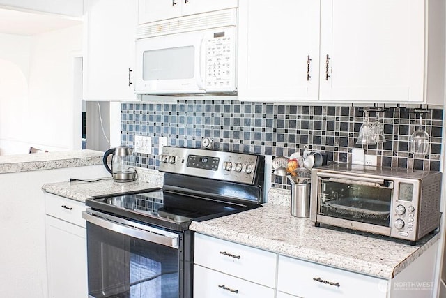 2916 Robin Ave, Bremerton, WA 98310 - kitchen with stainless steel range with electric cooktop, white cabinetry, tasteful backsplash, and white microwave