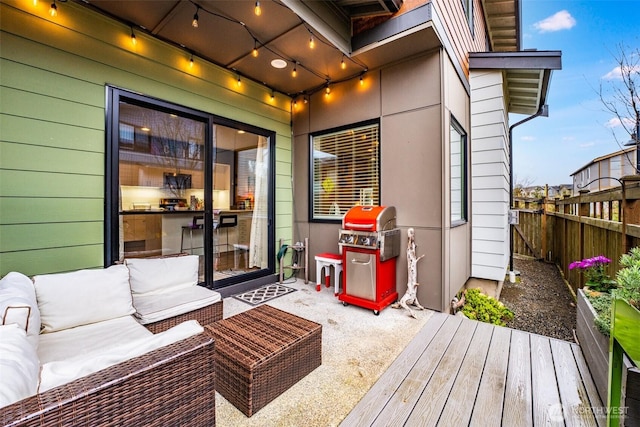 deck featuring fence, an outdoor hangout area, area for grilling, and a patio