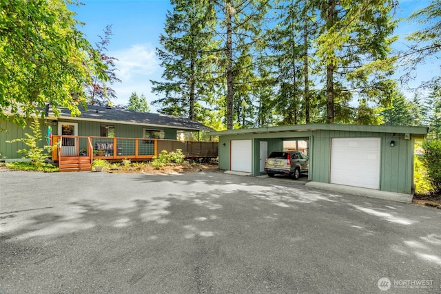 131 E Vine Maple Ln, Union, WA 98592 - view of front of home with an outdoor structure, a detached garage, and a wooden deck