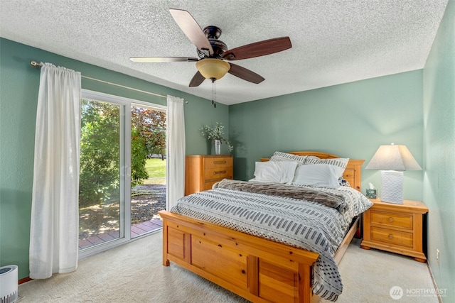 131 E Vine Maple Ln, Union, WA 98592 - carpeted bedroom with access to exterior, a ceiling fan, and a textured ceiling