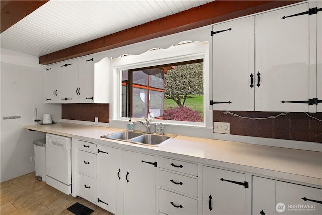 kitchen featuring light countertops, white cabinets, backsplash, dishwasher, and a sink