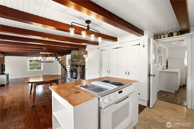 kitchen with electric stove, butcher block countertops, a chandelier, beamed ceiling, and decorative light fixtures