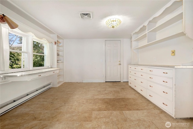 interior space with visible vents and baseboard heating