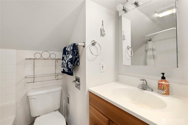 bathroom featuring lofted ceiling, a textured ceiling, vanity, and toilet
