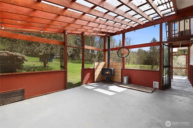 unfurnished sunroom with a wood stove