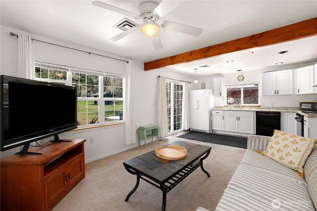 living room featuring beamed ceiling, visible vents, ceiling fan, and baseboards