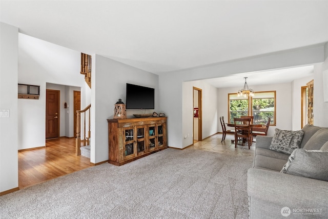 327 Keach Ct, Steilacoom, WA 98388 - carpeted living area with stairs, a chandelier, and baseboards