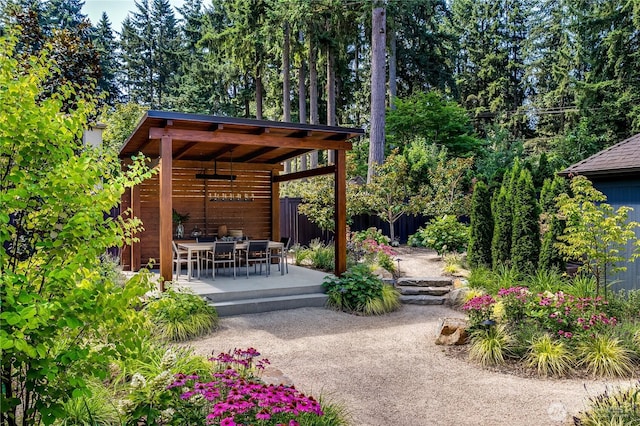 view of yard with outdoor dining space, fence, and a patio