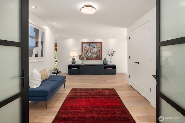corridor with light wood-style flooring and recessed lighting