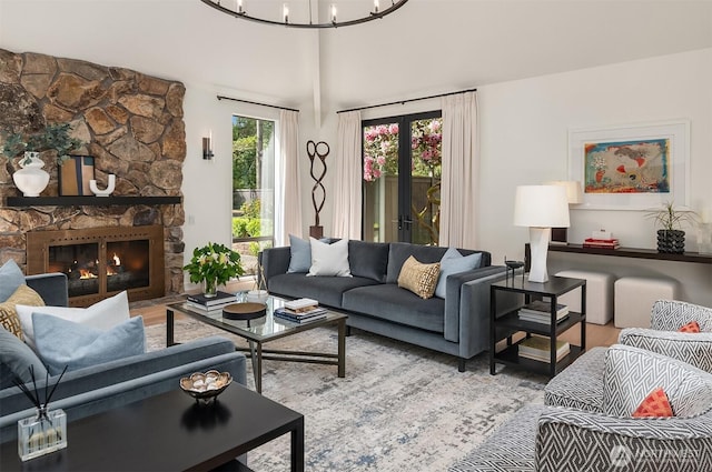 living room featuring wood finished floors, a chandelier, and a fireplace