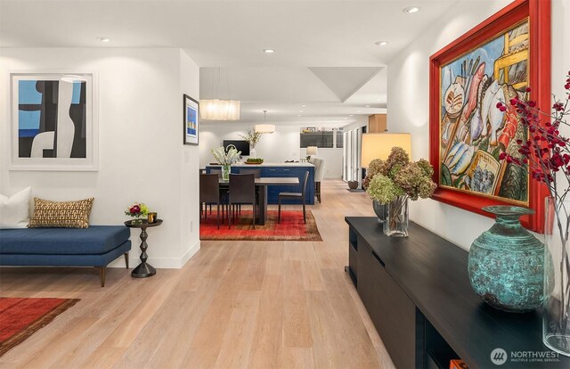 hallway with light wood-type flooring, recessed lighting, and baseboards