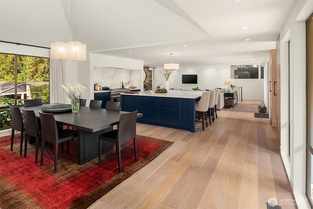 dining space with light wood-type flooring and recessed lighting